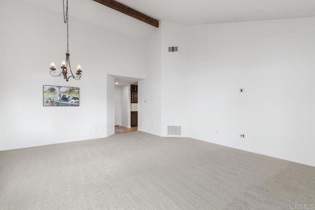 empty room featuring beamed ceiling, carpet flooring, high vaulted ceiling, and a notable chandelier