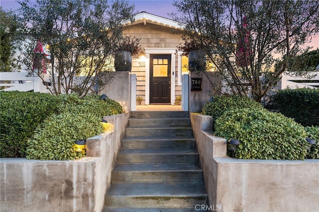 view of exterior entry at dusk