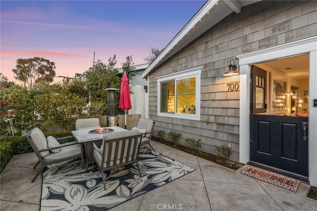 patio terrace at dusk with an outdoor fire pit