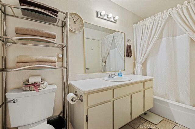 bathroom featuring vanity, tile patterned flooring, shower / bath combo, and toilet