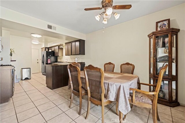 dining room with visible vents, ceiling fan, and light tile patterned floors