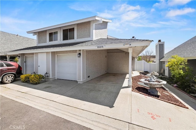 view of front facade featuring roof with shingles, fence, stucco siding, and concrete driveway