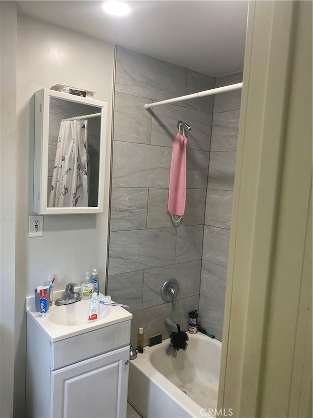 bathroom featuring vanity and shower / bath combo with shower curtain