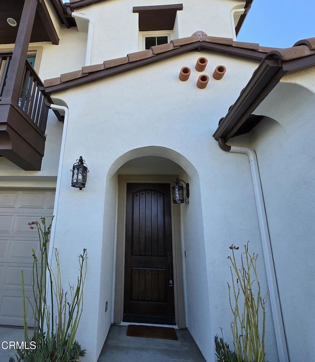 doorway to property with a garage