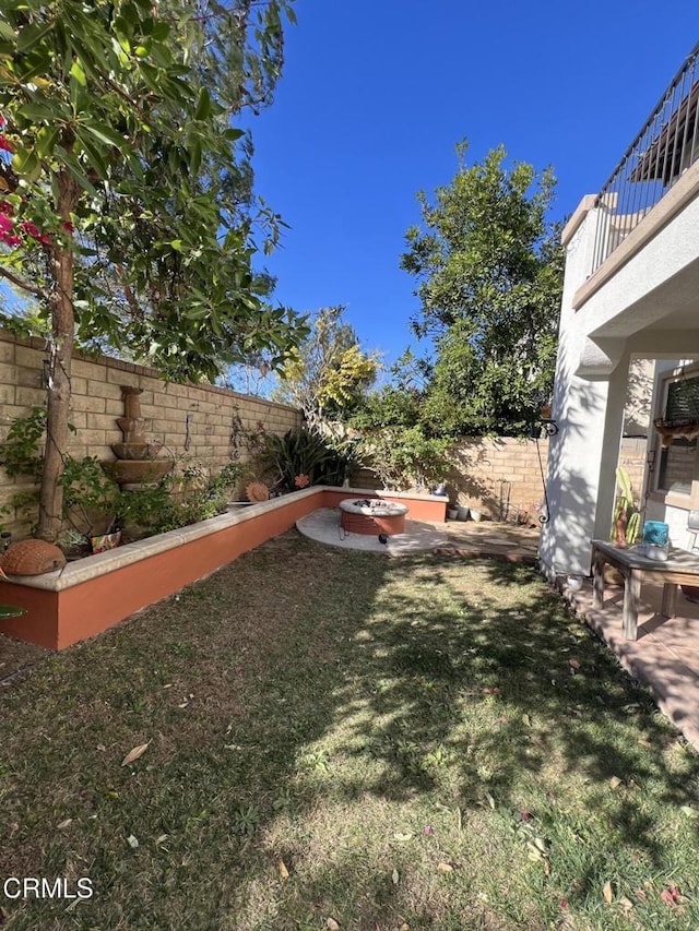 view of yard featuring a balcony and a patio