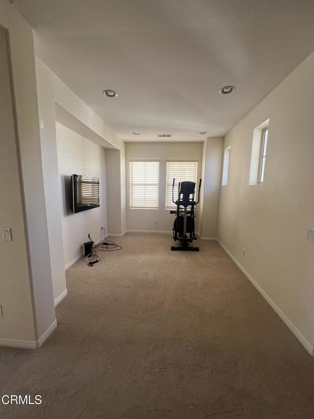 exercise room with light carpet