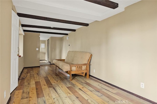 sitting room with beam ceiling and light hardwood / wood-style flooring