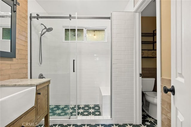 bathroom with walk in shower, vanity, and toilet