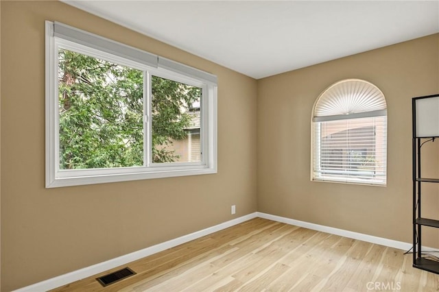 empty room with light hardwood / wood-style floors