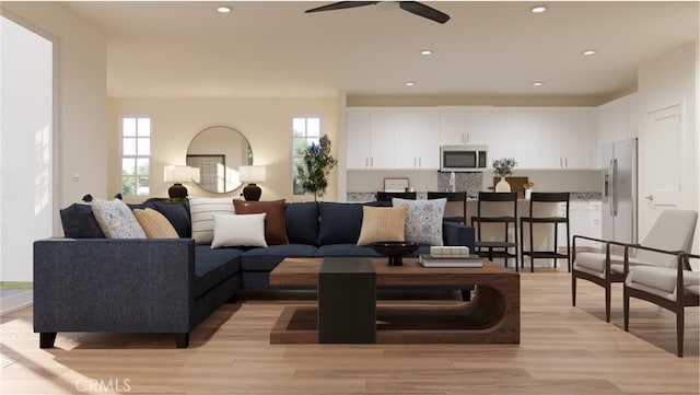 living room with light hardwood / wood-style flooring and ceiling fan