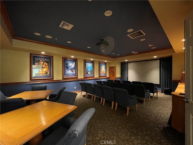 carpeted home theater room with a raised ceiling, visible vents, and recessed lighting