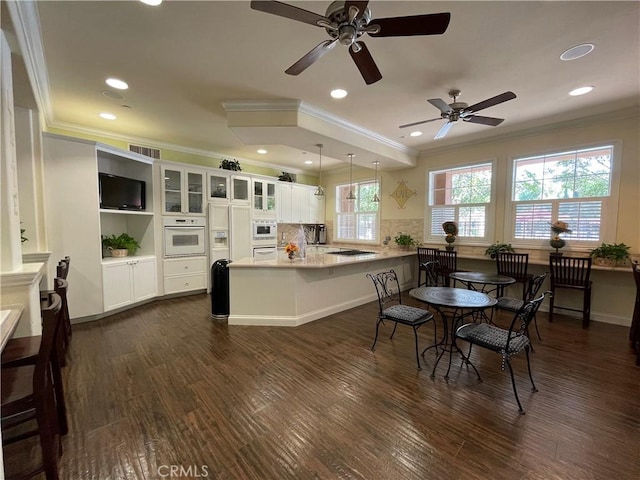 dining area with visible vents, dark wood finished floors, crown molding, and recessed lighting