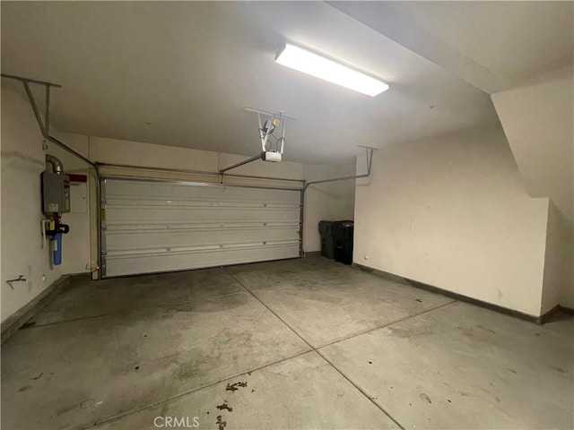 garage featuring water heater, baseboards, and a garage door opener