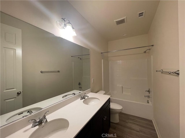 bathroom featuring visible vents, a sink, and toilet