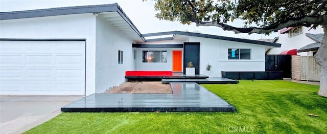 back of house featuring a yard and a garage