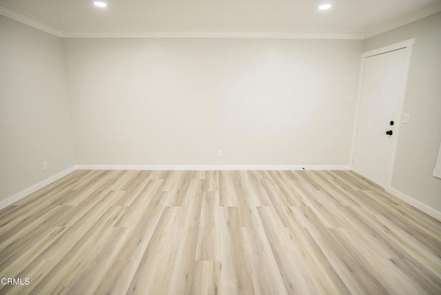 empty room with ornamental molding and light hardwood / wood-style flooring