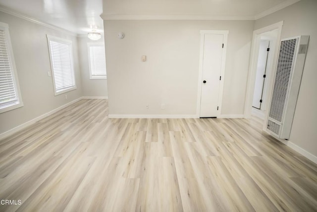 unfurnished room with crown molding and light hardwood / wood-style flooring