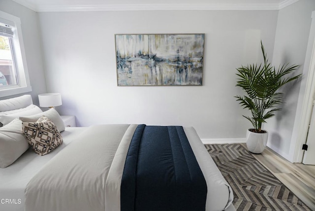 bedroom with wood-type flooring and crown molding