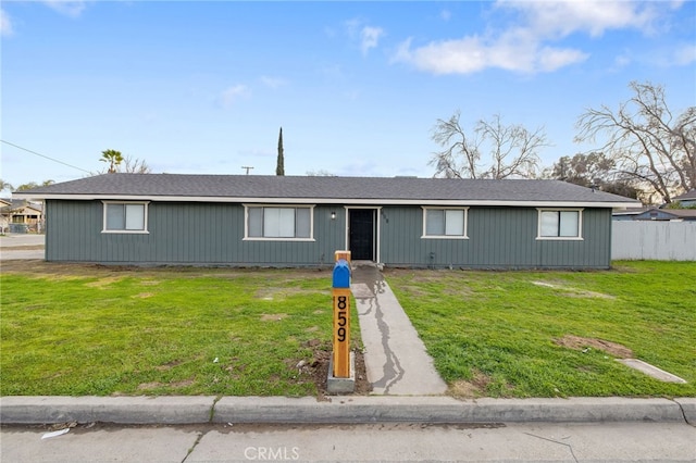 single story home featuring a front lawn