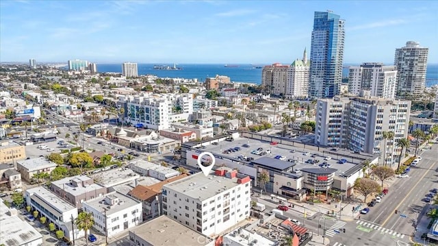drone / aerial view with a city view and a water view