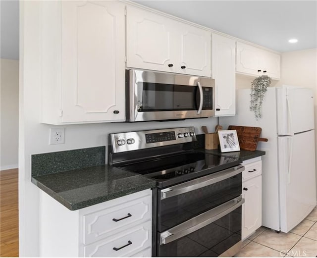 kitchen with light tile patterned floors, recessed lighting, white cabinets, and appliances with stainless steel finishes