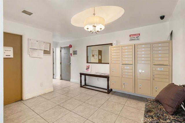 view of property's community with an inviting chandelier, mail area, and visible vents
