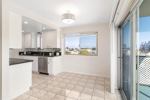 kitchen with a sink, dark countertops, recessed lighting, white cabinetry, and dishwasher