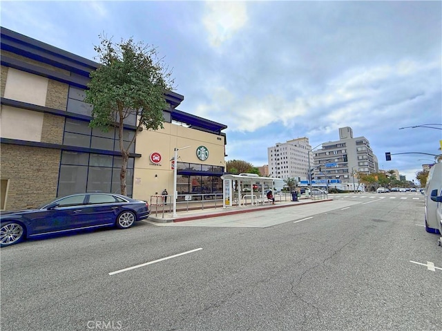 view of road with curbs, street lighting, and sidewalks