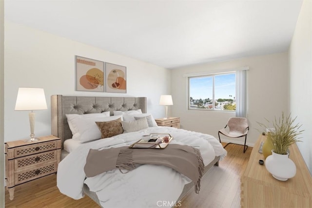 bedroom featuring baseboards and light wood-style flooring