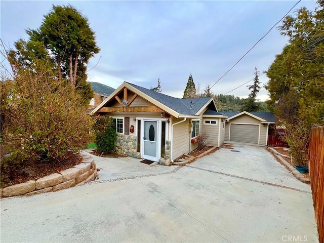 view of front of house featuring a garage and an outdoor structure