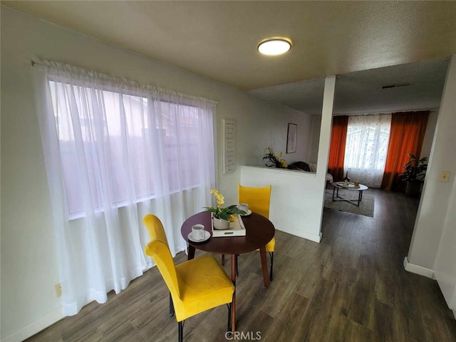 dining area featuring dark wood-type flooring