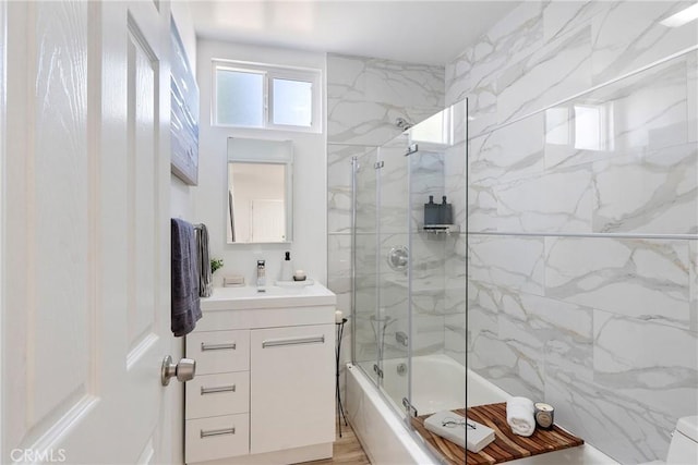 bathroom with vanity and enclosed tub / shower combo