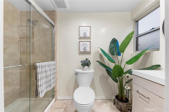 bathroom with tile patterned flooring, vanity, a shower with shower door, and toilet