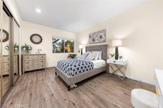 bedroom with a closet and light wood-type flooring