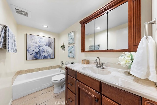 bathroom featuring vanity, tile patterned floors, a tub, and toilet