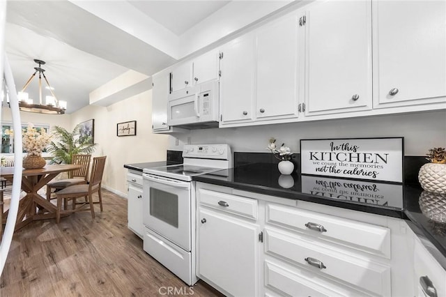 kitchen featuring an inviting chandelier, white appliances, light hardwood / wood-style floors, and white cabinets