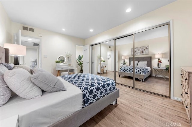 bedroom with light wood-type flooring and a closet