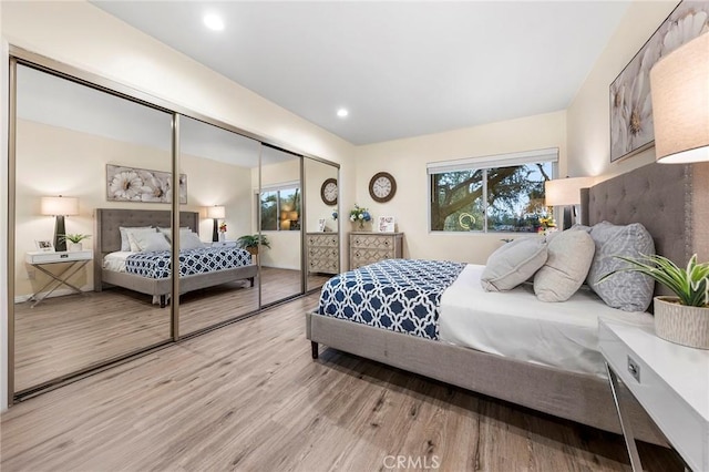 bedroom with a closet and light hardwood / wood-style flooring