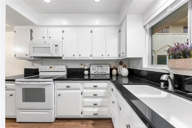 kitchen with white cabinetry, white appliances, dark hardwood / wood-style flooring, and sink