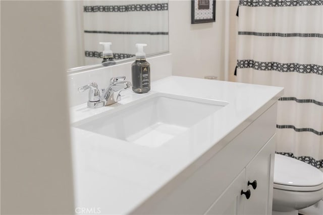 full bathroom with vanity and toilet