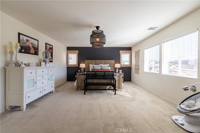 bedroom featuring light carpet and visible vents