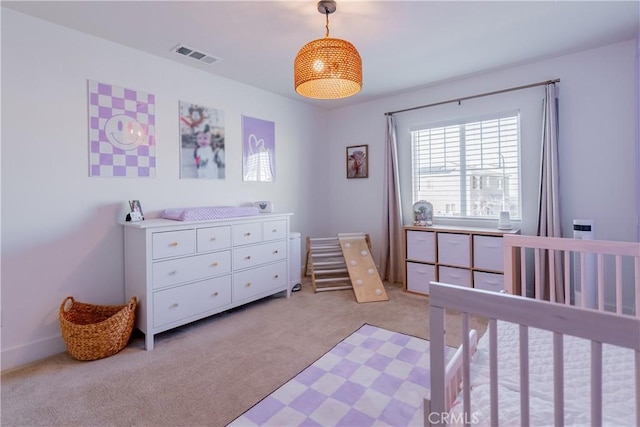 bedroom featuring visible vents and light colored carpet