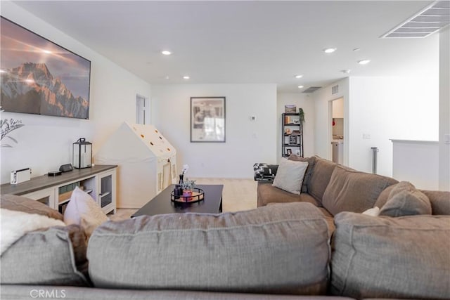 living area featuring visible vents and recessed lighting