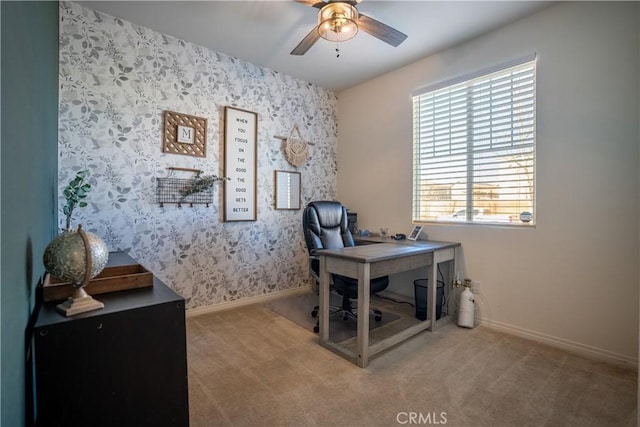 carpeted office space featuring ceiling fan, baseboards, and wallpapered walls