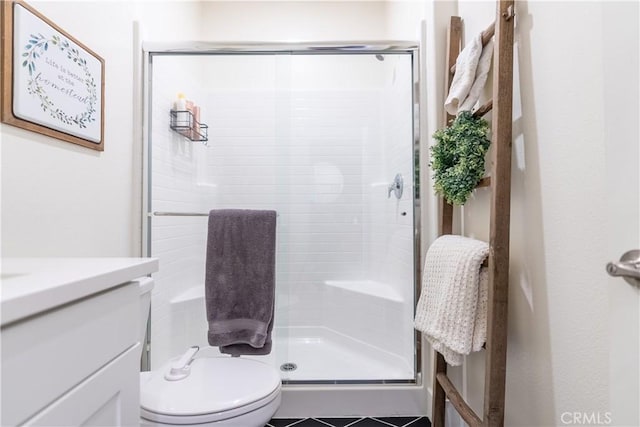 full bathroom featuring toilet, a shower stall, and vanity