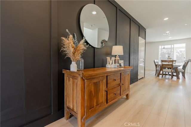 corridor with light wood-type flooring and recessed lighting