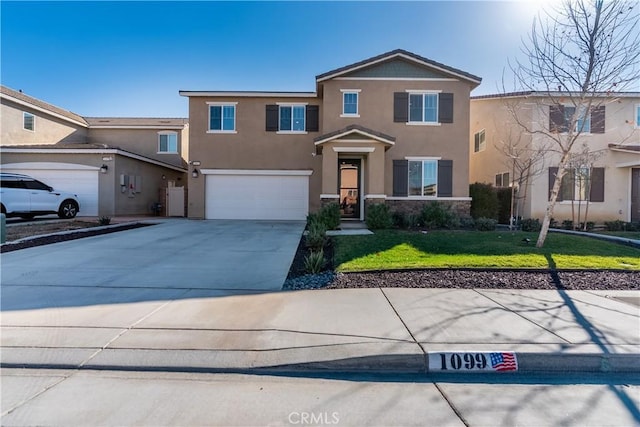 traditional-style home with stucco siding, a front yard, a garage, stone siding, and driveway