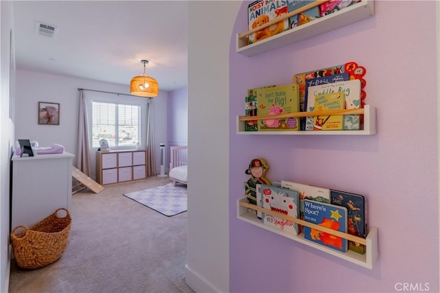 carpeted bedroom featuring visible vents