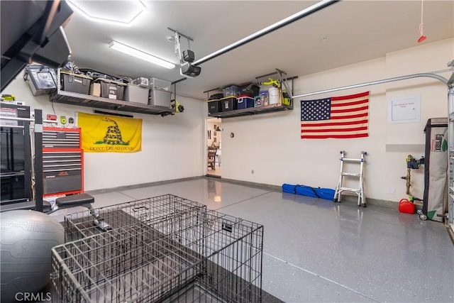 garage with baseboards and a garage door opener