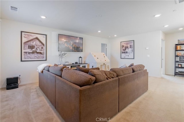 living room with recessed lighting, light colored carpet, and visible vents